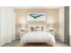 Cozy bedroom featuring a bed with a white duvet cover, side tables, and calming decor at 11864 Blue Diamond Trl, Parrish, FL 34219