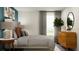 Modern bedroom showcasing a bed with throw pillows, table lamps, and dresser at 11864 Blue Diamond Trl, Parrish, FL 34219