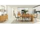 Bright dining room with light wood table and chairs, plus modern buffet with decorative lamps at 11864 Blue Diamond Trl, Parrish, FL 34219
