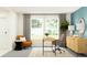 Comfortable home office with modern desk, neutral chair, and a cozy seating area at 11864 Blue Diamond Trl, Parrish, FL 34219