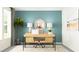 Stylish home office with a wood desk, round mirror, and a large window for natural light at 11864 Blue Diamond Trl, Parrish, FL 34219