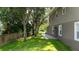 Spacious backyard with green lawn and mature trees, perfect for outdoor activities at 12170 Lake Allen Dr, Largo, FL 33773