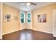 Bedroom featuring hardwood floors, two windows and decorative art at 12170 Lake Allen Dr, Largo, FL 33773