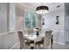 Elegant dining room with chandelier, light-colored walls, and modern decor at 12170 Lake Allen Dr, Largo, FL 33773
