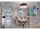 Dining room with stylish light fixture, and view into the spacious living room at 12170 Lake Allen Dr, Largo, FL 33773