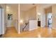 Hallway with hardwood floors leading to bathroom, bedrooms, and stairs to first floor at 12170 Lake Allen Dr, Largo, FL 33773