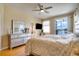 View of main bedroom featuring a dresser, ceiling fan, and sliding glass doors at 12170 Lake Allen Dr, Largo, FL 33773