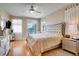 Spacious main bedroom with walkout access, hardwood floors and an elegant ceiling fan at 12170 Lake Allen Dr, Largo, FL 33773
