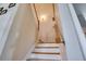 Stairway with wood and white painted steps and handrail and light wall color at 12170 Lake Allen Dr, Largo, FL 33773