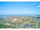Expansive aerial view capturing a community with beautiful waterways, lush trees, and clear skies at 12501 Ulmerton Rd # 14, Largo, FL 33774