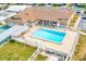 Community pool area featuring lounge chairs, tables, covered area and grill, perfect for outdoor entertainment at 12501 Ulmerton Rd # 14, Largo, FL 33774