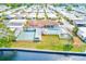 Aerial view of a community featuring a pool, clubhouse, and recreational facilities along the waterfront at 12501 Ulmerton Rd # 14, Largo, FL 33774