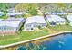Aerial view of a home with lake view, patio, green lawn, and easy access to the community's waterfront at 12501 Ulmerton Rd # 14, Largo, FL 33774