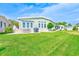 Spacious backyard with lush green lawn, a patio area for entertaining, and a well-maintained exterior at 12501 Ulmerton Rd # 14, Largo, FL 33774