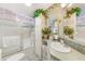 Well-maintained bathroom with decorative plants, a vanity, and a shower-tub combination at 12501 Ulmerton Rd # 14, Largo, FL 33774