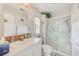 Well-lit bathroom with a decorative shower door and patterned wallpaper at 12501 Ulmerton Rd # 14, Largo, FL 33774