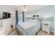 Cozy bedroom featuring a comfortable bed, soft blue walls, and a window with natural light at 12501 Ulmerton Rd # 14, Largo, FL 33774