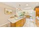 Kitchen island and view of dining area with comfortable seating and natural light at 12501 Ulmerton Rd # 14, Largo, FL 33774