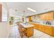 Open kitchen featuring large island with seating and view into dining area at 12501 Ulmerton Rd # 14, Largo, FL 33774