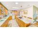 Bright kitchen featuring an island with cooktop and breakfast bar seating at 12501 Ulmerton Rd # 14, Largo, FL 33774