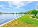 Scenic view of the lake, lush green lawn, and blue skies creating a peaceful and picturesque setting at 12501 Ulmerton Rd # 14, Largo, FL 33774