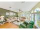Inviting living room featuring large windows, comfortable sofas, and a ceiling fan at 12501 Ulmerton Rd # 14, Largo, FL 33774