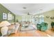 Bright living room with large windows, wood floors, and comfortable seating at 12501 Ulmerton Rd # 14, Largo, FL 33774