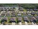 Aerial view of a community with well-maintained homes, lush greenery, and a scenic pond at 12618 Sandpine Reserve Pl, Gibsonton, FL 33534