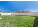 Large backyard with a lush green lawn and a pristine white fence, perfect for outdoor enjoyment at 12618 Sandpine Reserve Pl, Gibsonton, FL 33534