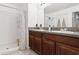 Bathroom with a granite countertop, double sink vanity, and a shower and tub combination at 12618 Sandpine Reserve Pl, Gibsonton, FL 33534