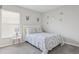 A cozy bedroom featuring a queen-sized bed with patterned bedding and carpet flooring at 12618 Sandpine Reserve Pl, Gibsonton, FL 33534