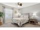 Charming bedroom with gray walls, carpet flooring, decorative curtains and a wood nightstand at 12618 Sandpine Reserve Pl, Gibsonton, FL 33534