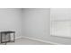 Bedroom with white walls, a window with blinds, carpet flooring, and a black end table at 12618 Sandpine Reserve Pl, Gibsonton, FL 33534