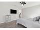 Bedroom with carpet flooring, a mounted TV, and view of the ensuite bathroom at 12618 Sandpine Reserve Pl, Gibsonton, FL 33534