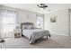 Bright bedroom featuring carpet flooring, a queen bed, and stylish nightstands with lamps at 12618 Sandpine Reserve Pl, Gibsonton, FL 33534