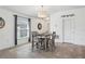 Cozy dining room with stylish chandelier, gray wood furniture, and natural lighting at 12618 Sandpine Reserve Pl, Gibsonton, FL 33534