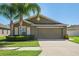 Beautiful one-story home showcasing manicured landscaping and a spacious two-car garage at 12618 Sandpine Reserve Pl, Gibsonton, FL 33534