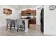 Modern kitchen boasting a breakfast bar, granite countertops, and stainless steel appliances at 12618 Sandpine Reserve Pl, Gibsonton, FL 33534