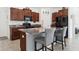 Well-equipped kitchen featuring a central island, granite counters, and modern appliances at 12618 Sandpine Reserve Pl, Gibsonton, FL 33534