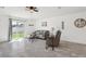 Bright living room with a sliding door to the backyard, ceiling fan and light gray sectional sofa at 12618 Sandpine Reserve Pl, Gibsonton, FL 33534