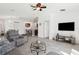 Open-concept living room with tile flooring, a ceiling fan, and view of the kitchen and dining area at 12618 Sandpine Reserve Pl, Gibsonton, FL 33534
