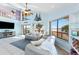 Open living room with a large TV and panoramic windows showcasing scenic outdoor views at 13514 Garris Dr, Hudson, FL 34667