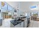 Open-concept living space featuring a gourmet kitchen, a living area, and panoramic water views at 13514 Garris Dr, Hudson, FL 34667