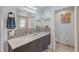 Well-lit bathroom with double vanities, granite countertops, mosaic backsplash and modern fixtures at 1361 46Th Ne Ave, St Petersburg, FL 33703
