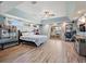 Serene bedroom with a king bed, natural light, wood-look flooring, and a view of the water and boat dock from the sliding glass doors at 1361 46Th Ne Ave, St Petersburg, FL 33703