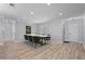 Elegant dining room with a modern table, stylish chairs, wood-look floors, and plantation shutters at 1361 46Th Ne Ave, St Petersburg, FL 33703