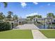 Wide-angle view of a backyard dock with boat lifts and neighborhood canal on a sunny day at 1361 46Th Ne Ave, St Petersburg, FL 33703