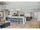 Open-concept living space with kitchen island with seating and modern appliances at 1361 46Th Ne Ave, St Petersburg, FL 33703