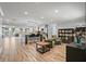 Open concept living space boasts a kitchen island with bar seating, two armchairs, and tile floors at 1361 46Th Ne Ave, St Petersburg, FL 33703