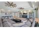Comfortable living room with a large sectional sofa, entertainment center, wood-look floors, and ample space for entertaining guests at 1361 46Th Ne Ave, St Petersburg, FL 33703